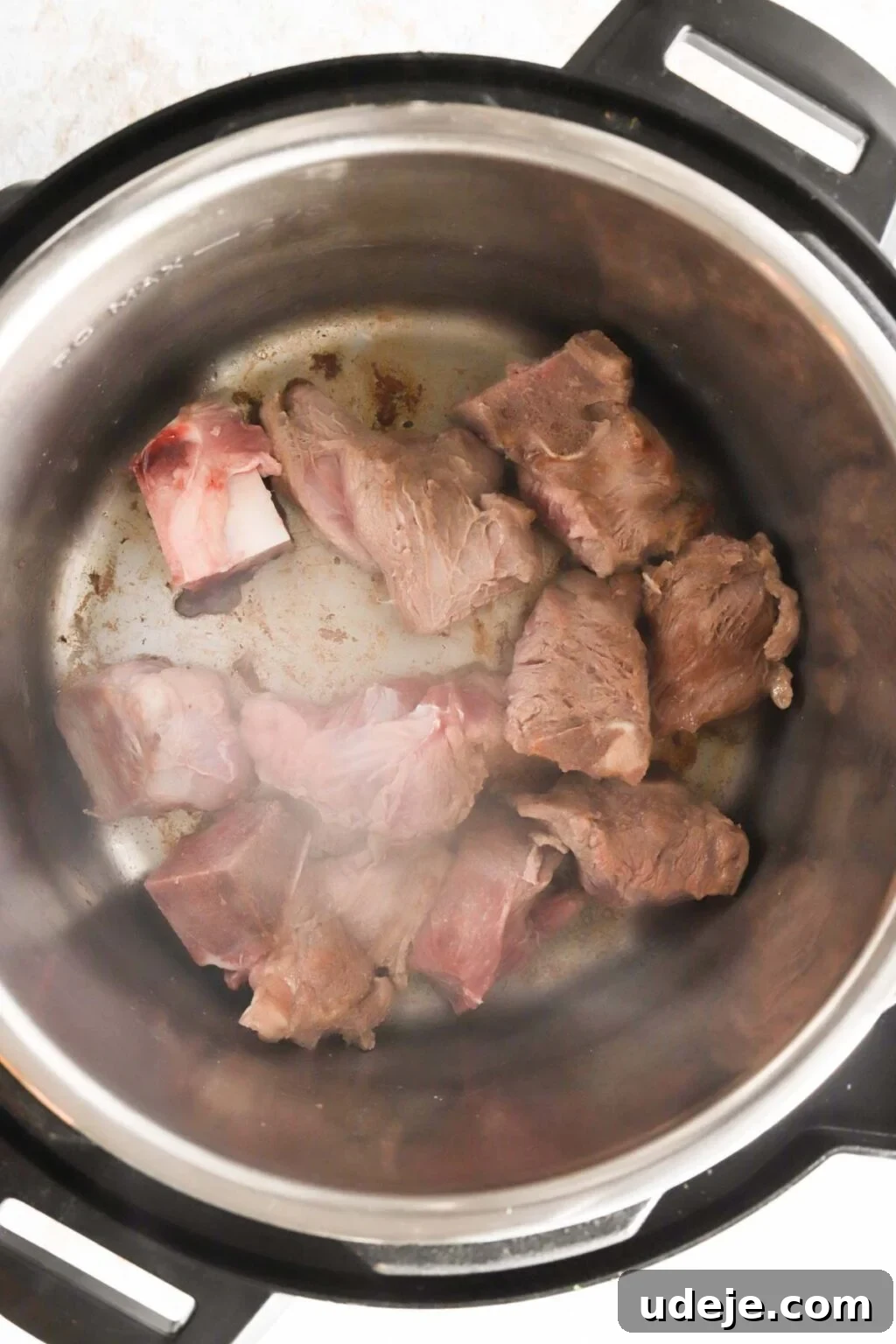 Effortless Green Bean Stew Instant Pot and Stovetop 7 veal cubes browning in an Instant Pot, developing rich flavor