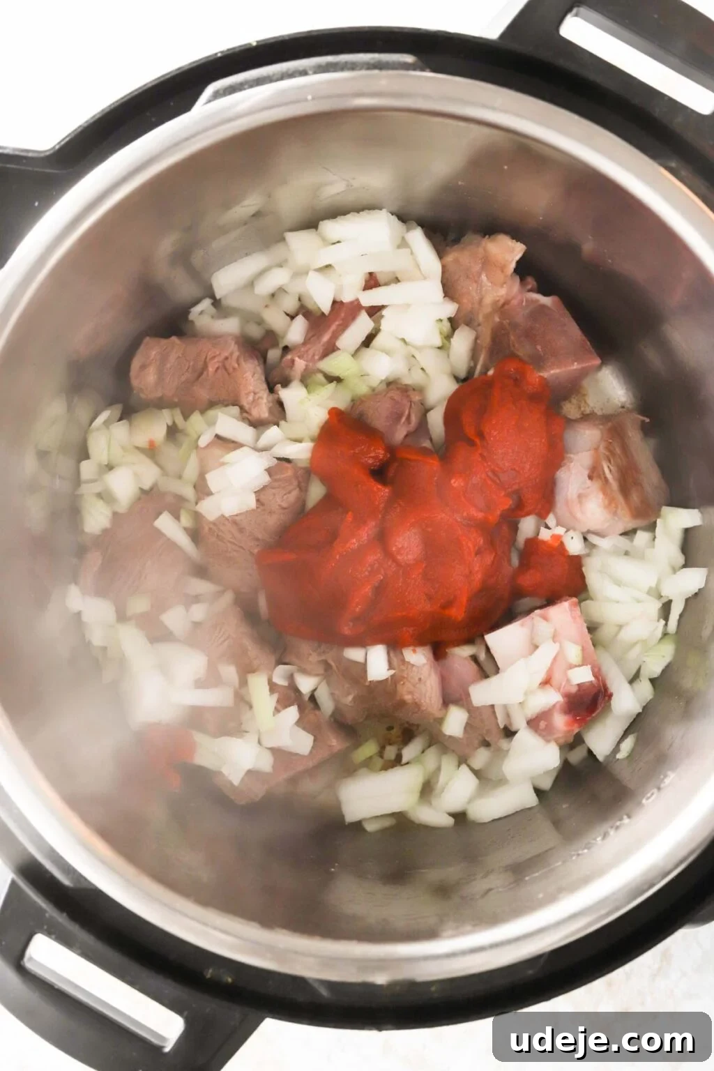 Effortless Green Bean Stew Instant Pot and Stovetop 9 green beans, veal, and onions simmering with tomato paste in an Instant Pot