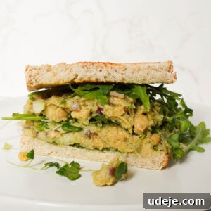 Vegan Chickpea Salad Sandwich with creamy chickpea filling, avocado, and lettuce on sourdough bread.