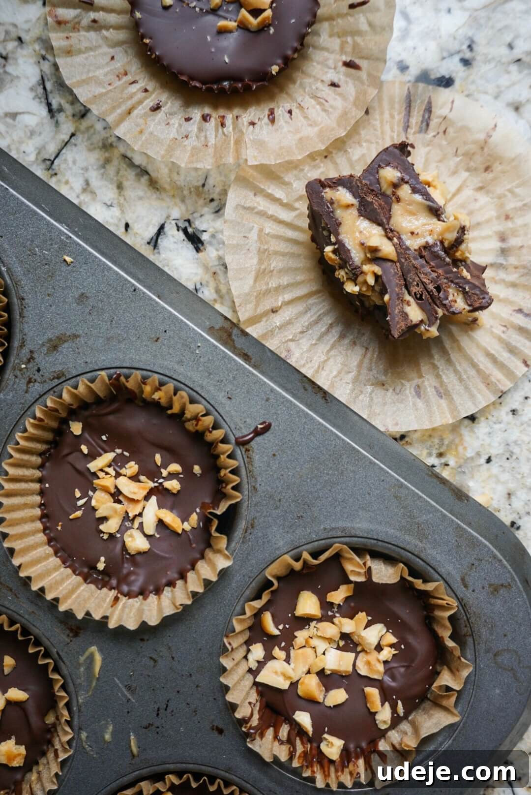 Dreamy Vegan Chocolate Peanut Butter Yogurt Bites 3 A close-up of a finished Vegan Chocolate Peanut Butter Yogurt Cup, showing layers of chocolate and creamy peanut butter filling, topped with nuts. It's a perfect summer treat, made with just six ingredients and tastes like Reese's.