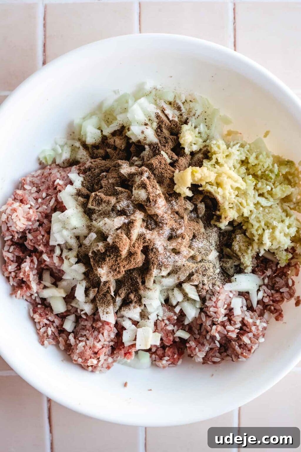 Authentic Lebanese Cabbage Rolls 6 Stuffing for cabbage consisting of rice, ground beef, onions, garlic and spices in a white bowl