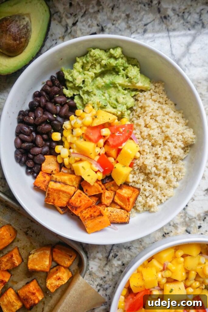 Sweet Potato Sunshine Bowls with Mango Corn Fiesta 2 Sweet Potato Burrito Bowls served with a vibrant Mango Corn Salsa, offering a nourishing plant-based meal bursting with sweet, savory, and tangy flavors.