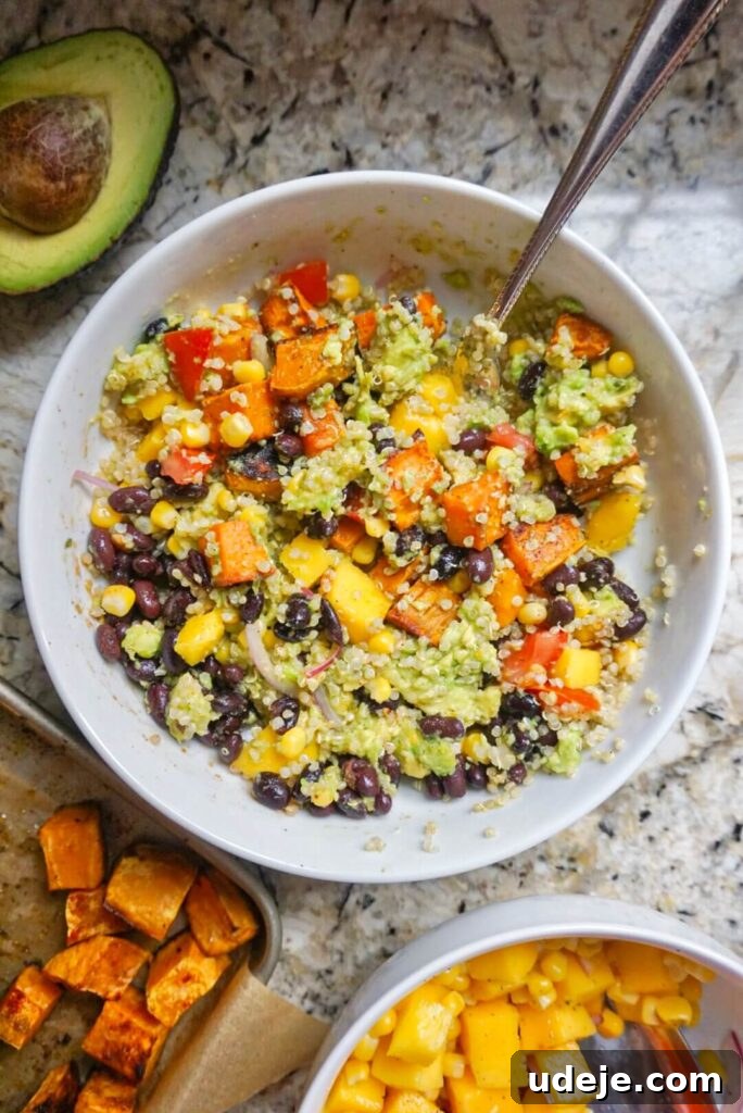 Sweet Potato Sunshine Bowls with Mango Corn Fiesta 3 A close-up of Sweet Potato Burrito Bowls highlighting the fresh Mango Corn Salsa, showcasing a symphony of sweet, savory, and tangy flavors in a nourishing plant-based meal.