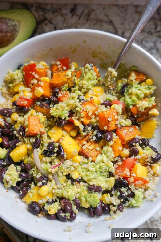 Sweet Potato Sunshine Bowls with Mango Corn Fiesta 6 A beautifully assembled Sweet Potato Burrito Bowl with Mango Corn Salsa, showcasing the vibrant ingredients and inviting presentation.