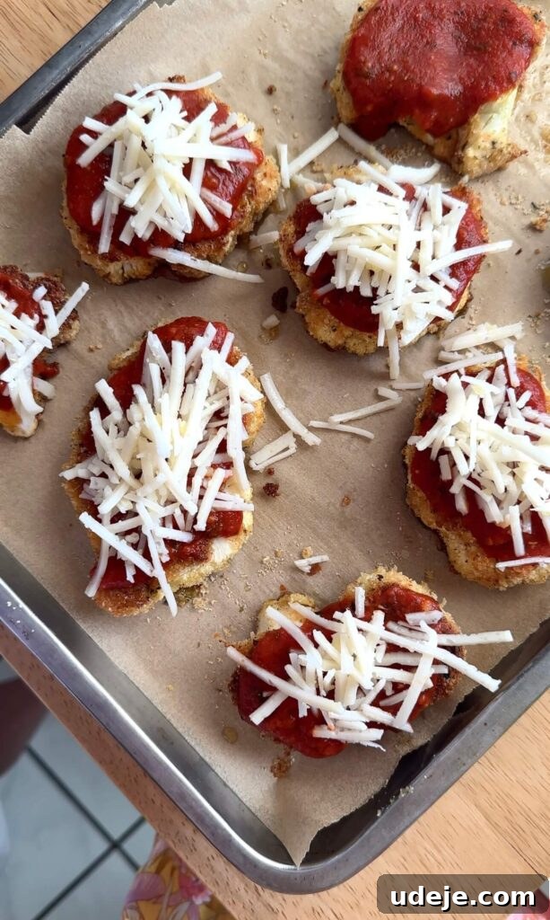 Roasted Cauliflower Parmesan 5 Baked cauliflower parmesan pieces layered with rich marinara sauce and melting vegan mozzarella cheese, fresh from the oven.
