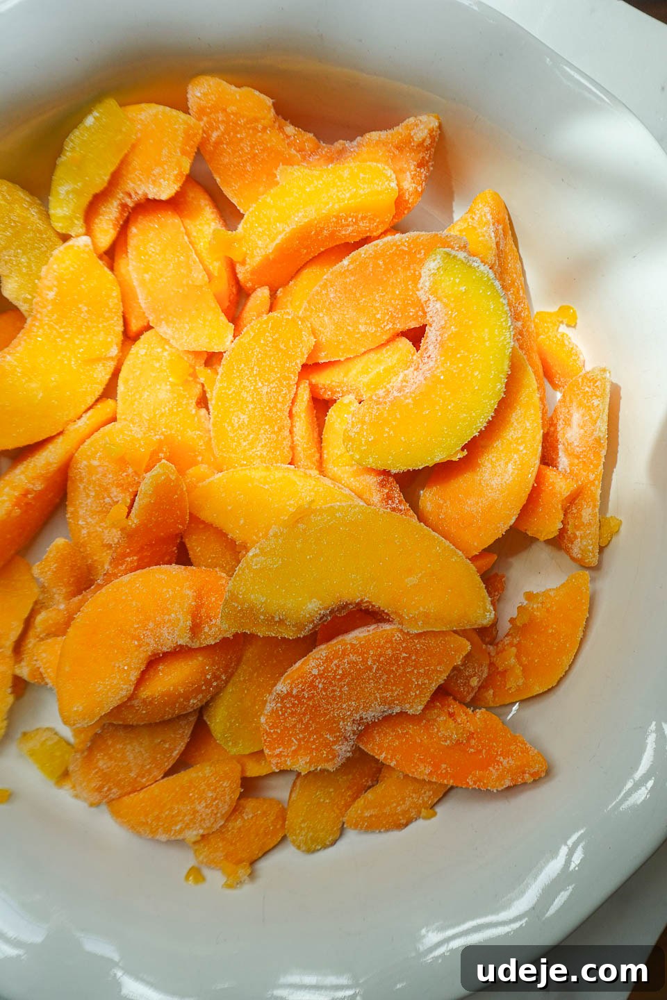Wholesome Peach Crumble 6 Freshly sliced peaches, perfectly prepared and arranged in a bowl, ready to form the luscious filling of the peach crisp.
