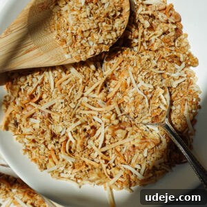 Simply Delicious Five Ingredient Healthy Granola 5 Overhead shot of freshly baked healthy granola with a wooden spoon, emphasizing its wholesome ingredients.