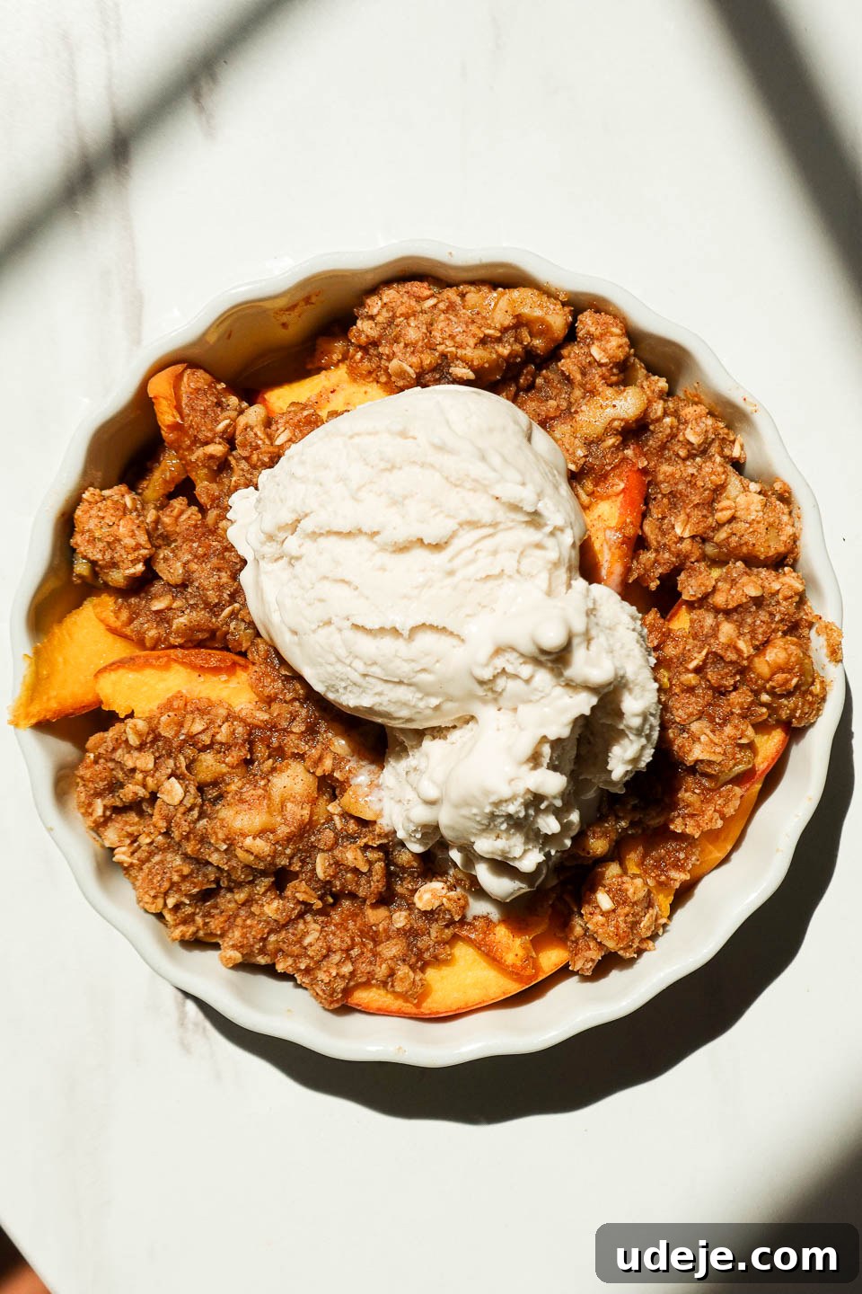 Healthy Vegan Gluten-Free Peach Crisp For One 3 Single serve peach crisp with vegan vanilla ice cream and crunchy granola
