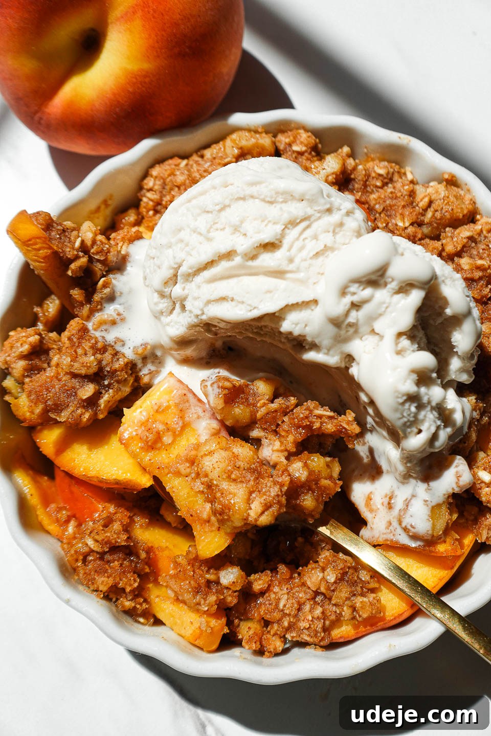 Healthy Vegan Gluten-Free Peach Crisp For One 5 Healthy single serve peach crisp with juicy baked peaches and nutty crisp topping in a ramekin with a spoon