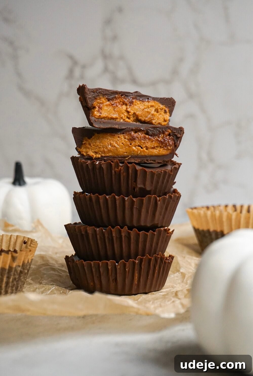 Autumn Peanut Butter Pumpkin Delights 2 Delicious Homemade Pumpkin Peanut Butter Cups, artfully arranged for a fall celebration. These vegan, gluten-free treats are ideal for autumn desserts.