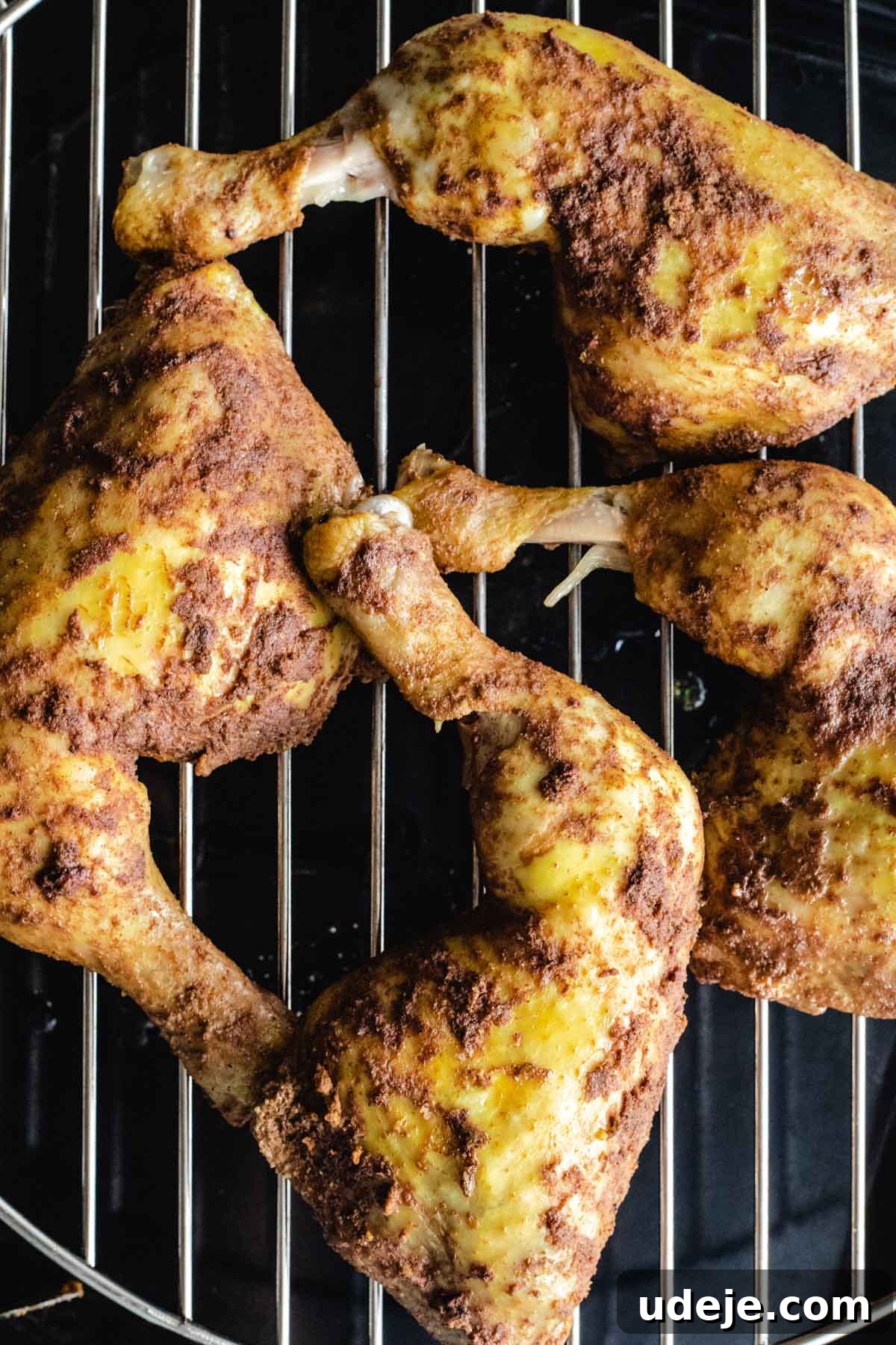 Yemeni Chicken Mandi with Fragrant Spiced Rice 11 Perfectly spiced chicken quarters arranged on a grill rack, ready for broiling to achieve a crispy skin.