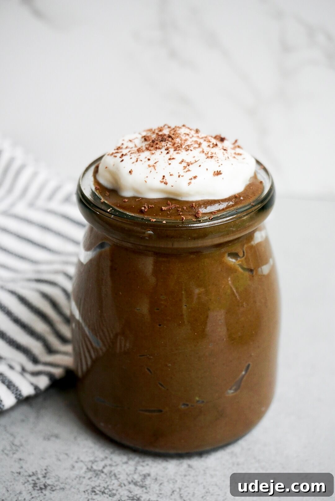 Decadent Chocolate Avocado Mousse 5 Healthy vegan chocolate avocado pudding made from avocados, cocoa powder, and maple syrup served in a small glass jar.