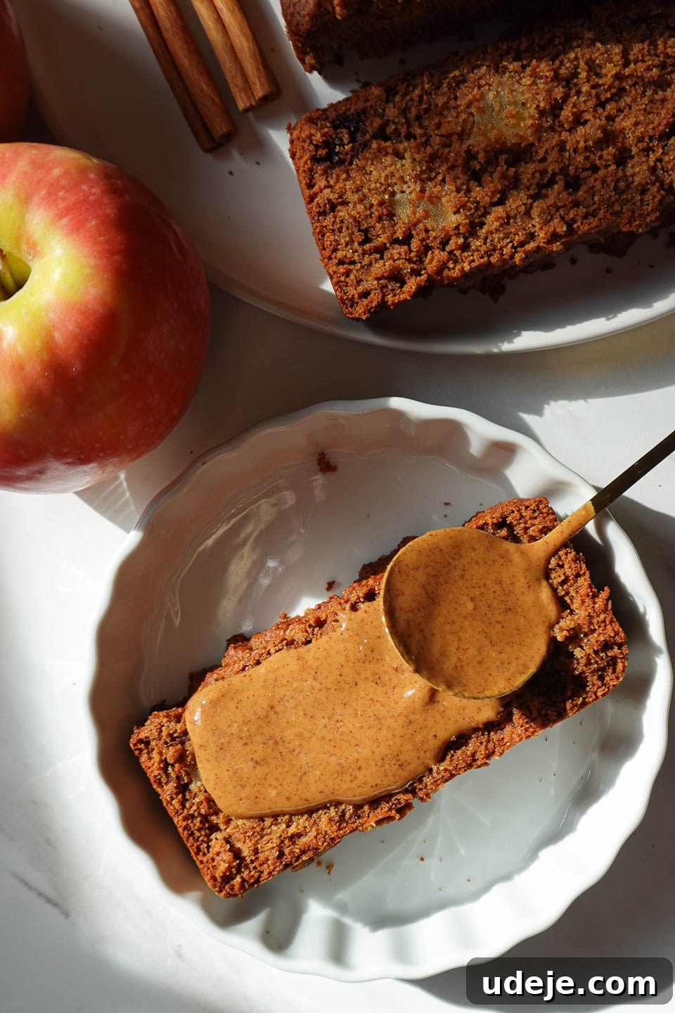 Wholesome Vegan Gluten-Free Apple Bread 3 Slice of delicious vegan apple bread served with almond butter on a plate, a perfect fall treat