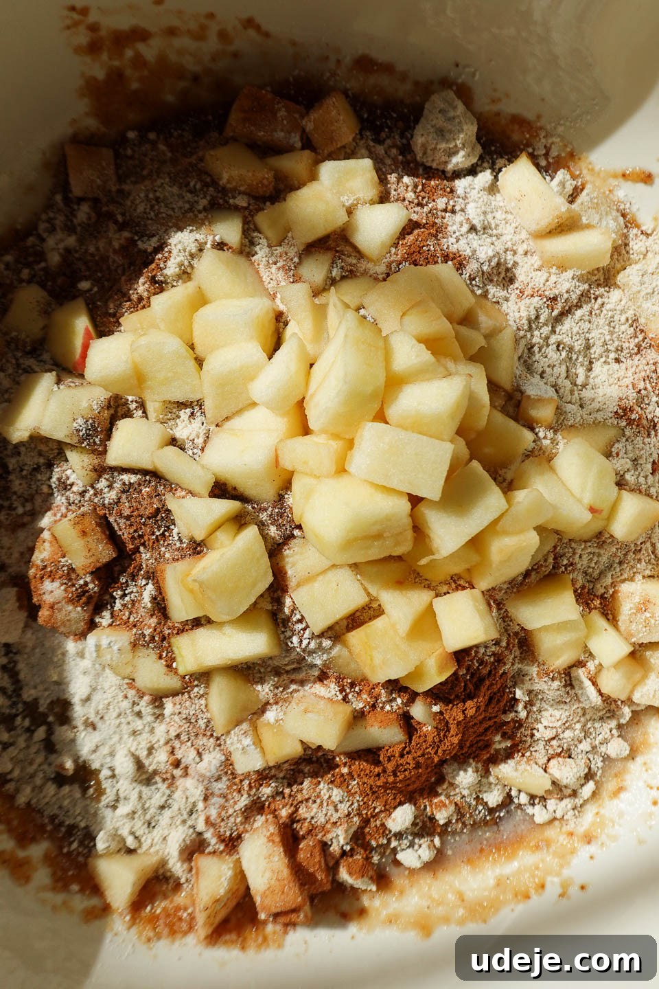 Wholesome Vegan Gluten-Free Apple Bread 6 Folding generous apple chunks into the rich, spiced apple bread batter for even distribution
