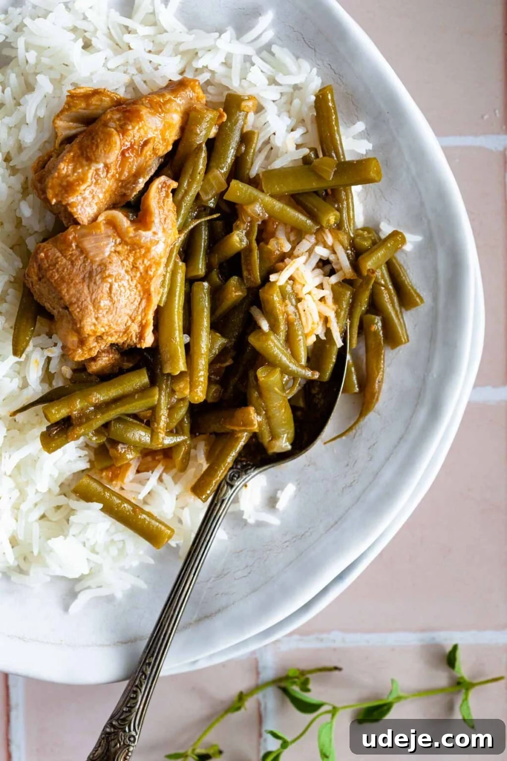 15 Middle Eastern Rice Dishes Weeknight Meals to Holiday Feasts 4 Green bean stew with veal served over rice on a white plate