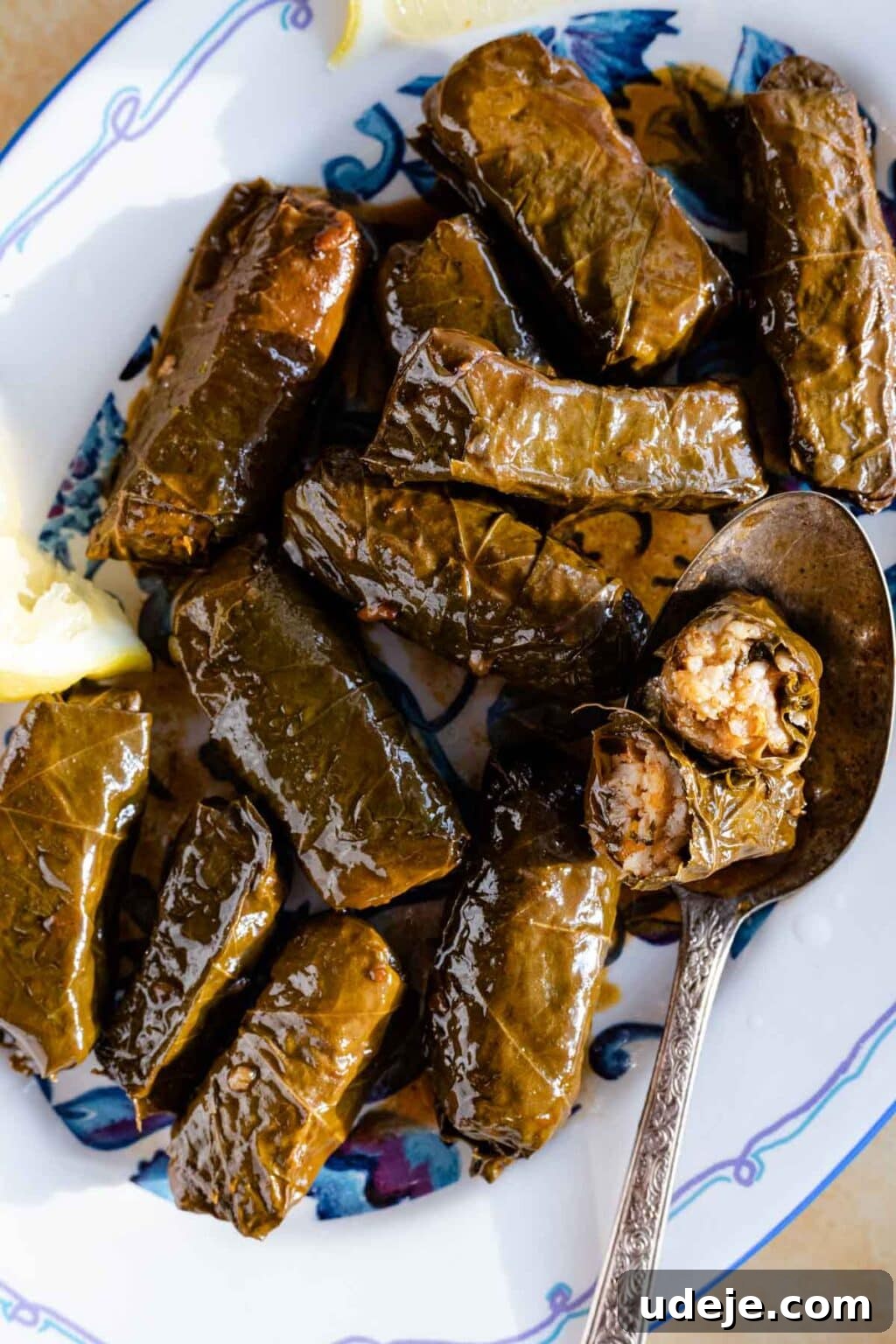15 Middle Eastern Rice Dishes Weeknight Meals to Holiday Feasts 6 vegetarian stuffed grape leaves served on a platter with one cut open to reveal rice