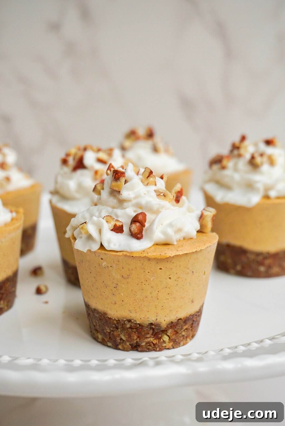Creamy Vegan Pumpkin Cheesecake Minis 2 Delightful No-Bake Mini Vegan Pumpkin Cheesecakes, a dairy-free, gluten-free, and refined sugar-free fall dessert. Perfect for holidays and easy to make.