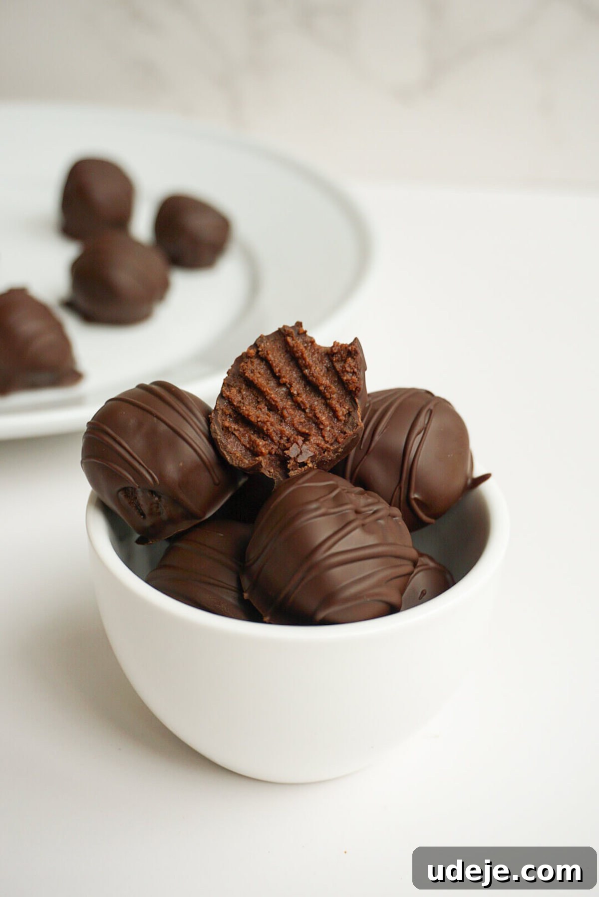 Sinfully Delicious Vegan Gluten Free Brownie Truffles 4 Brownie Batter Truffles beautifully arranged in a rustic mug, ready to be enjoyed