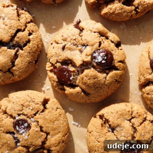 gluten-free and vegan chocolate chip cookies freshly baked on a baking sheet and sprinkled with flaky sea salt