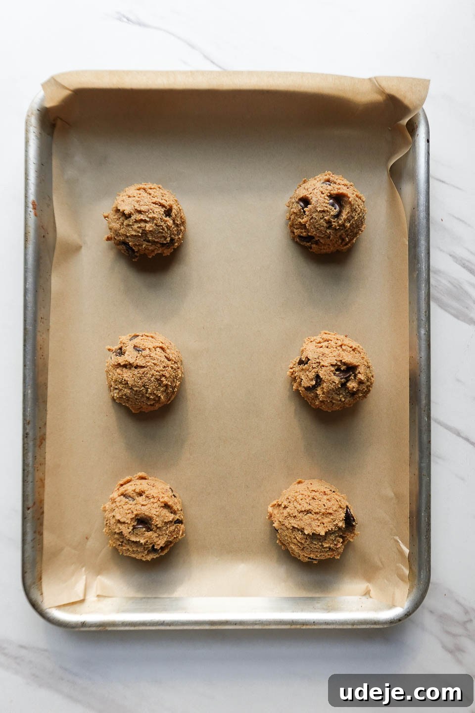 Melt-in-Your-Mouth Vegan Gluten-Free Chocolate Chip Cookies 10 Vegan chocolate chip cookies scooped onto a baking sheet