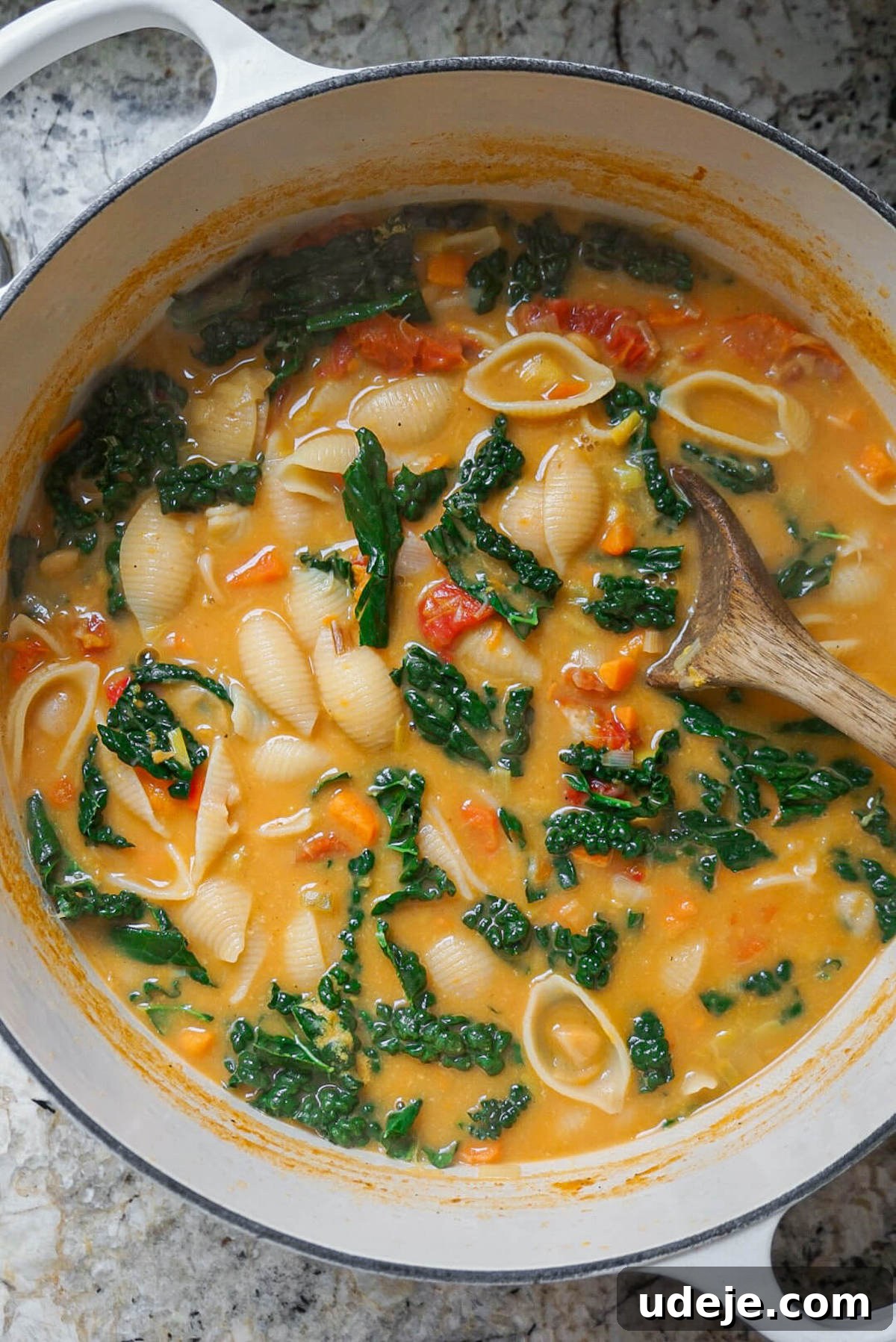 Velvety Tuscan Plant-Based Soup 2 A steaming bowl of Creamy Vegan Tuscan Soup, garnished with fresh herbs, showcasing its rich texture and vibrant vegetables like leeks, sweet potato, sun-dried tomatoes, and butter beans. Ideal for a cozy, plant-based meal.