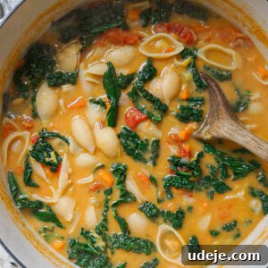 A bowl of creamy vegan Tuscan soup, garnished with fresh herbs, ready to be enjoyed.
