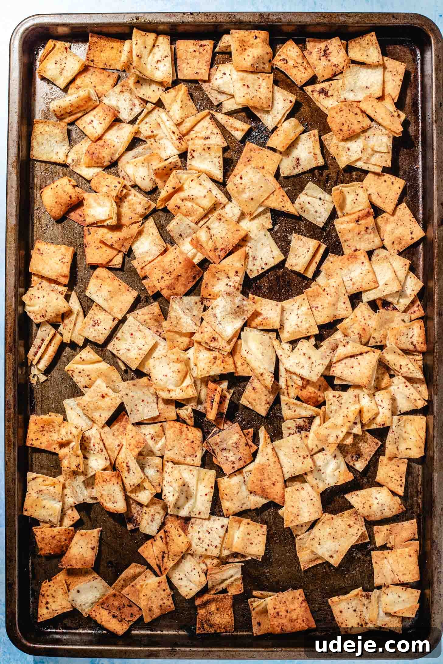 Mediterranean Eggplant Fatteh Delight 7 Golden toasted seasoned pita chips on a sheet pan, perfectly crispy.