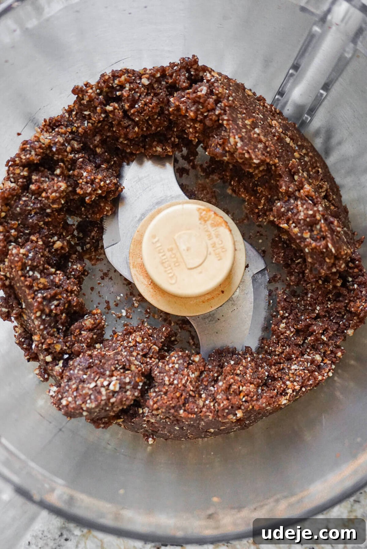 Indulgent No-Bake Vegan Gluten-Free Chocolate Turtles 3 Food processor containing oats, cocoa powder, Medjool dates, and pecans, ready to be blended into cookie dough.