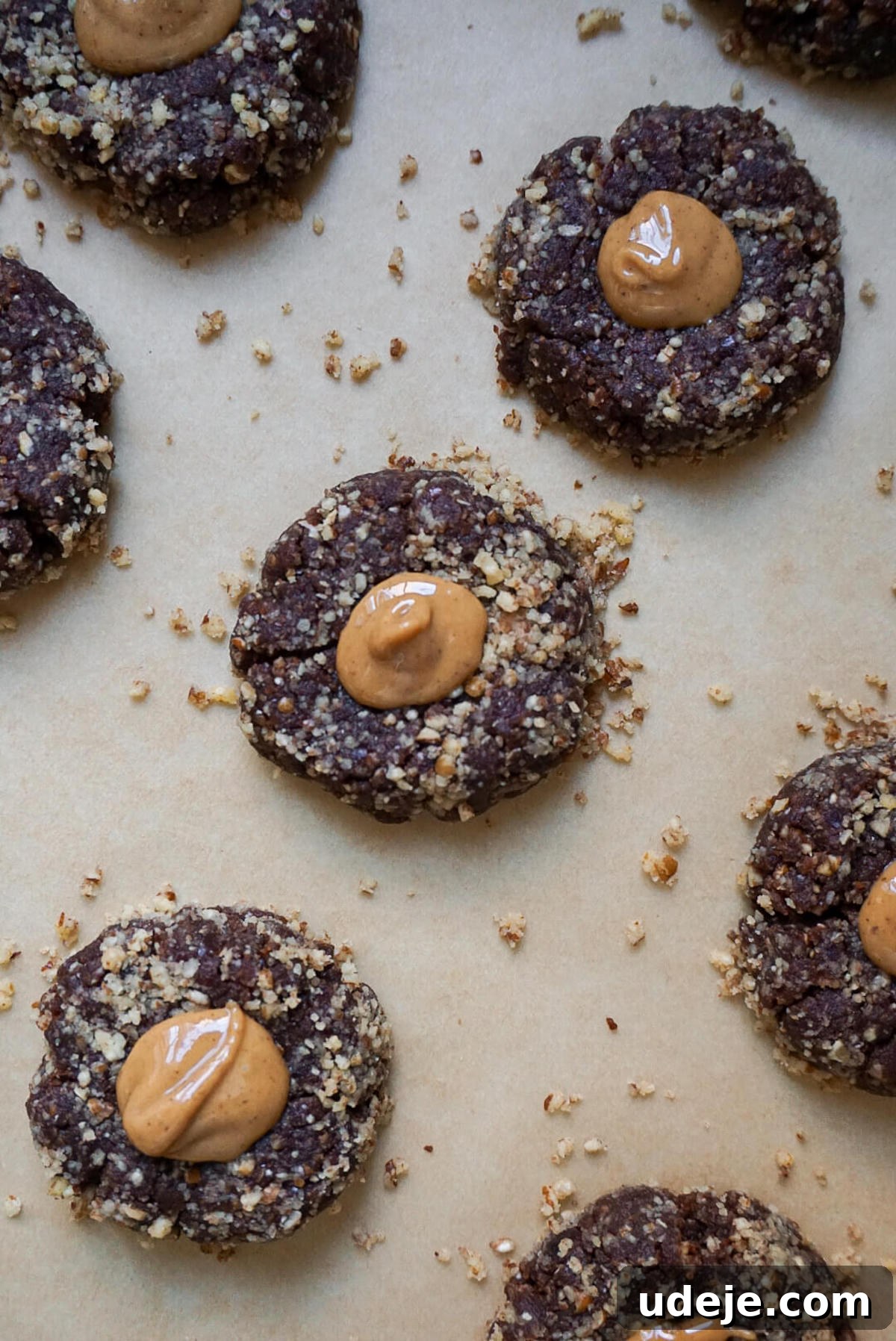 Indulgent No-Bake Vegan Gluten-Free Chocolate Turtles 4 Making an indent in a No Bake Chocolate Turtle Cookie using a teaspoon, preparing it for the peanut butter filling.