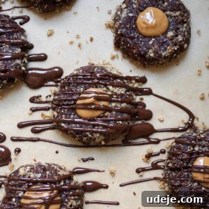 Indulgent No-Bake Vegan Gluten-Free Chocolate Turtles 6 A close-up of a No Bake Chocolate Turtle Cookie, showcasing its peanut butter center, crushed pecan coating, and chocolate drizzle.