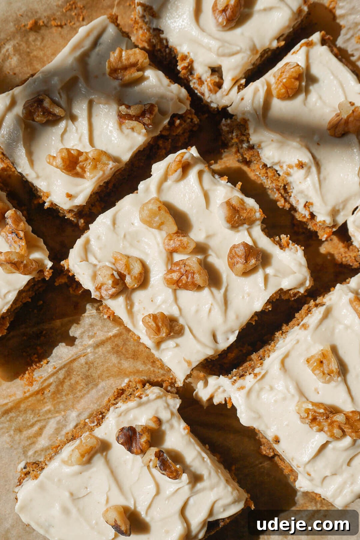 Wholesome Vegan Gluten Free Carrot Cake 3 overhead shot of healthy carrot cake sliced and topped with vegan cream cheese frosting and chopped walnuts