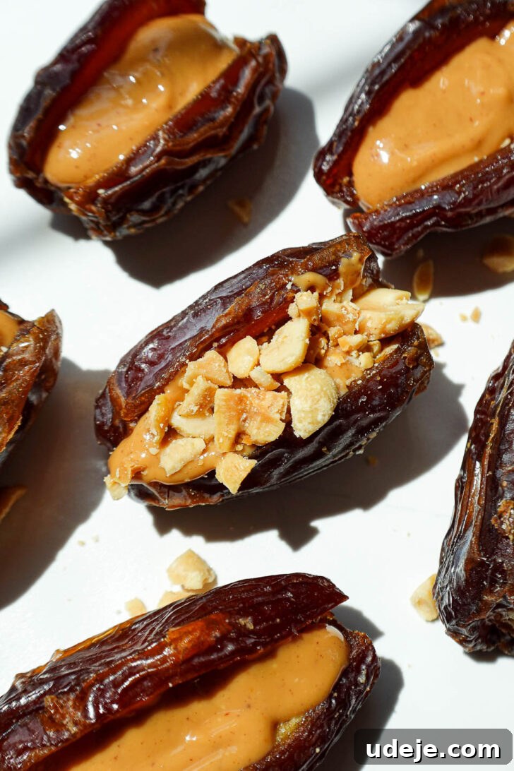Snickers Date Bombs 5 Process shot of Medjool dates being carefully pitted and prepared for stuffing.