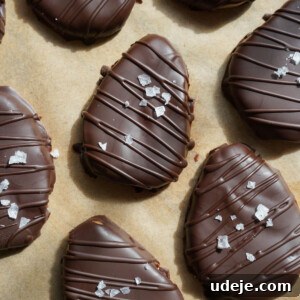 Finished plate of healthy 4-ingredient peanut butter eggs, coated in chocolate and sprinkled with sea salt.