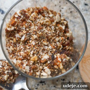 Rawnola is a no bake granola that's ready in 5 minutes, loaded with dates, pecans, oats, coconut flakes, chia seeds & other nutritious ingredients. It's naturally sweetened & insanely delicious!