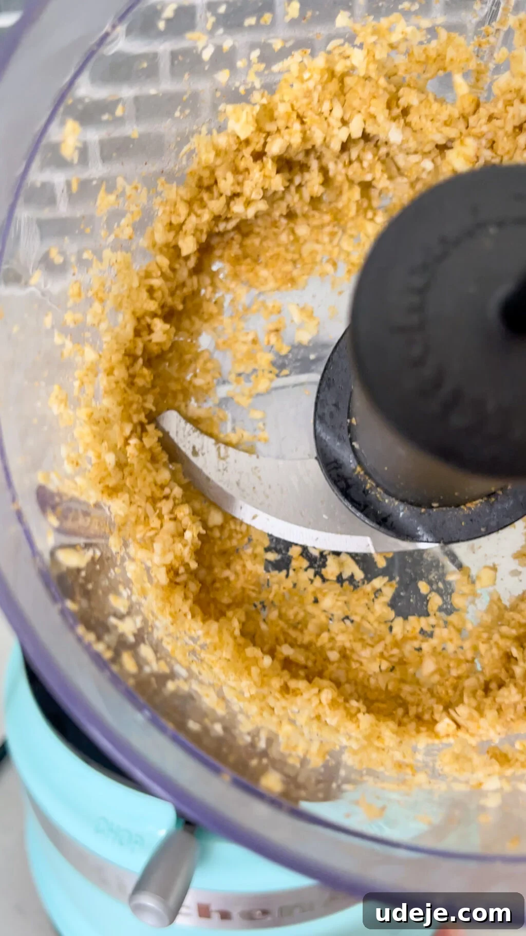Molokhia: A Timeless Tradition 10 Finely minced garlic and coriander paste in the bowl of a small food processor with the blade attached, demonstrating the perfect texture for the tasha.