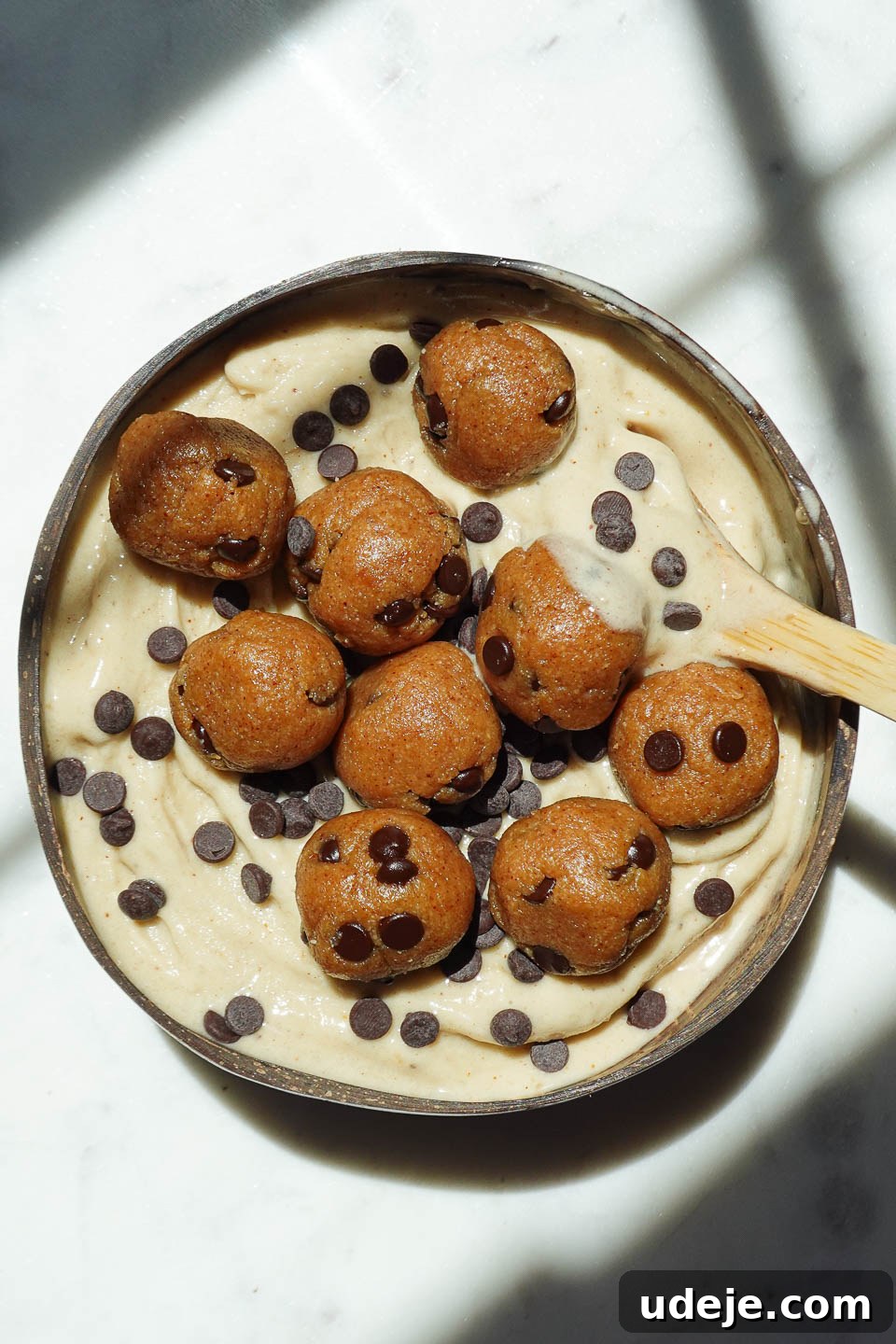 Wholesome Vegan Cookie Dough Bliss 2 Vegan cookie dough nice cream served in a bowl with chocolate chips and cookie dough pieces on top