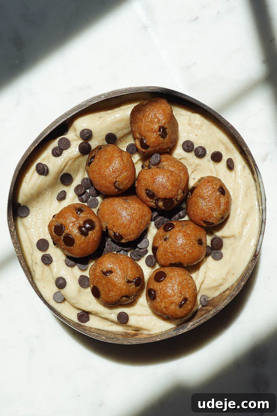 Wholesome Vegan Cookie Dough Bliss 7 Vegan cookie dough nice cream served in a bowl with chocolate chips and cookie dough pieces on top