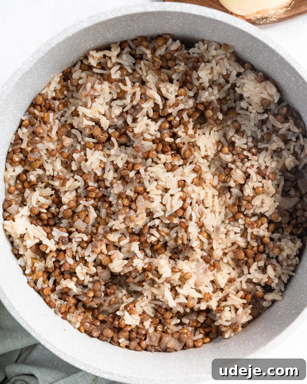 Egypt's Koshari: A Hearty Blend of Rice, Lentils and Pasta 13 cooked rice and lentils in a light pot with a green towel at the side