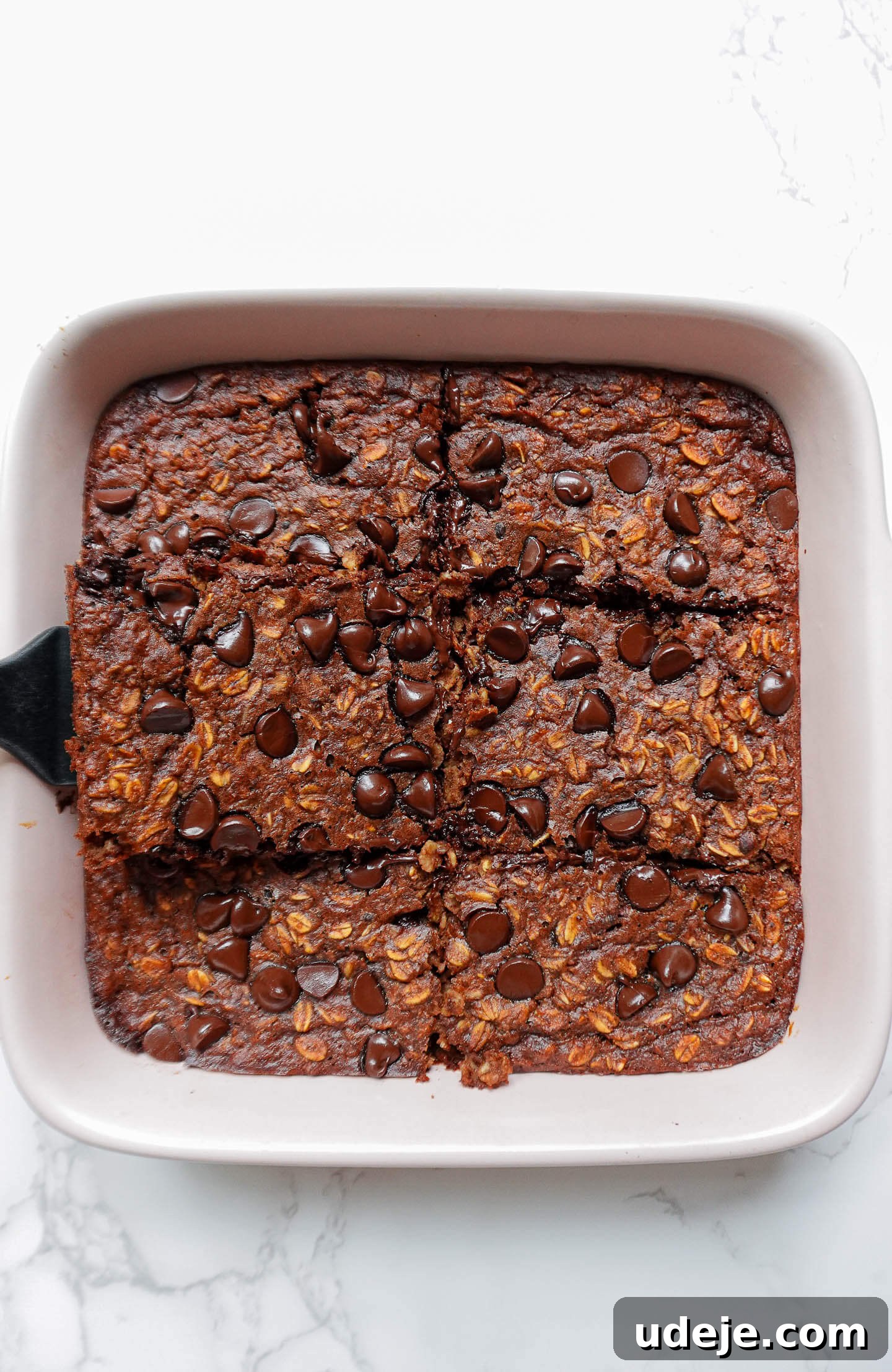 Decadent Chocolate Baked Oats 4 Mixing all ingredients in one bowl for Brownie Baked Oatmeal, highlighting the ease of preparation for this vegan breakfast recipe.