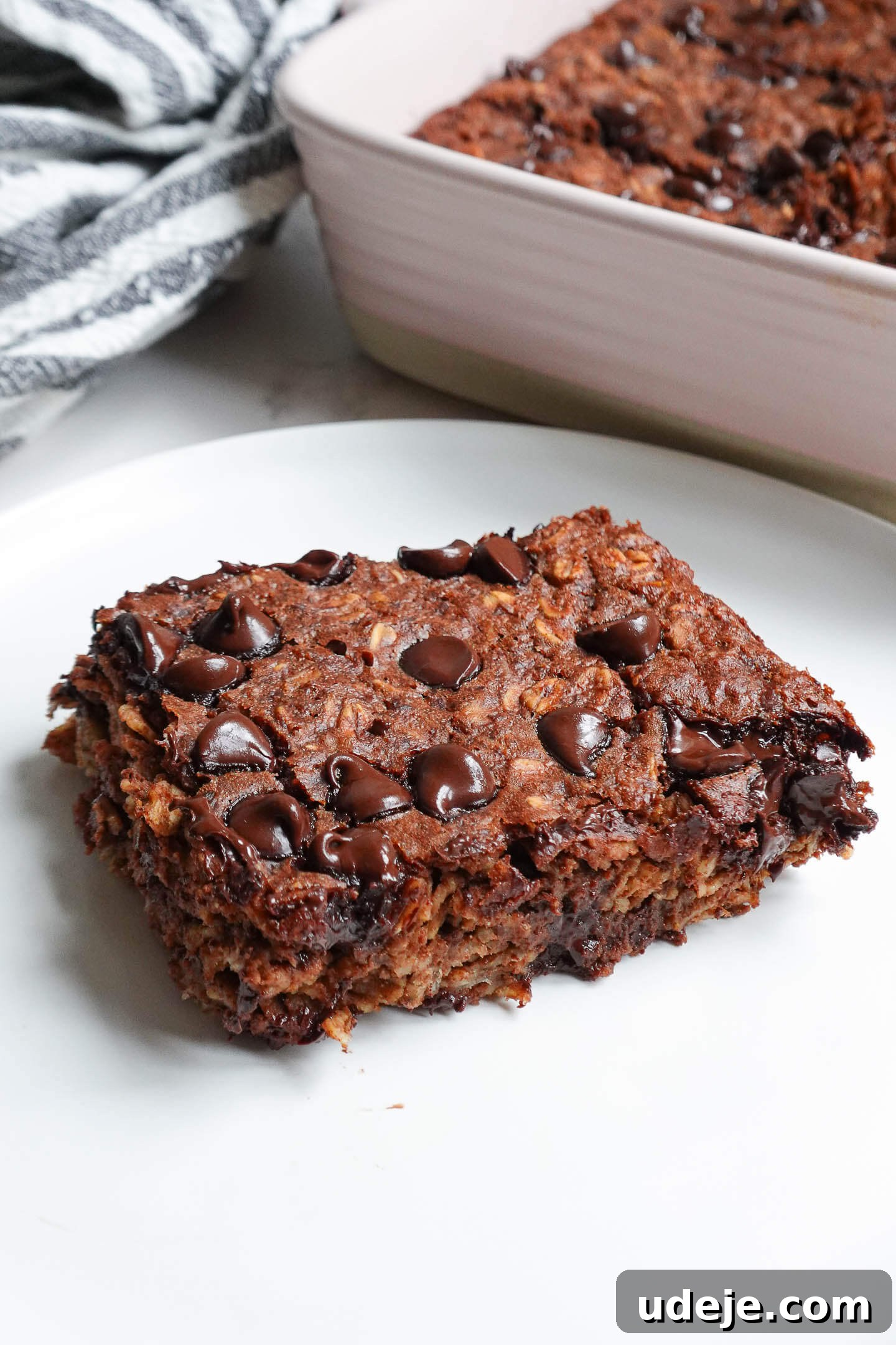 Decadent Chocolate Baked Oats 5 Individual serving of Brownie Baked Oatmeal topped with fresh raspberries and a drizzle of nut butter, a perfect healthy and vegan breakfast.
