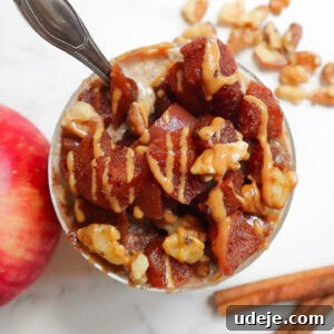Apple Pie Overnight Oats in a jar with cinnamon apples on top.