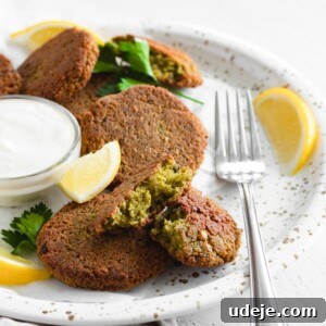 crispy baked falafel served in a plate with a dipping sauce
