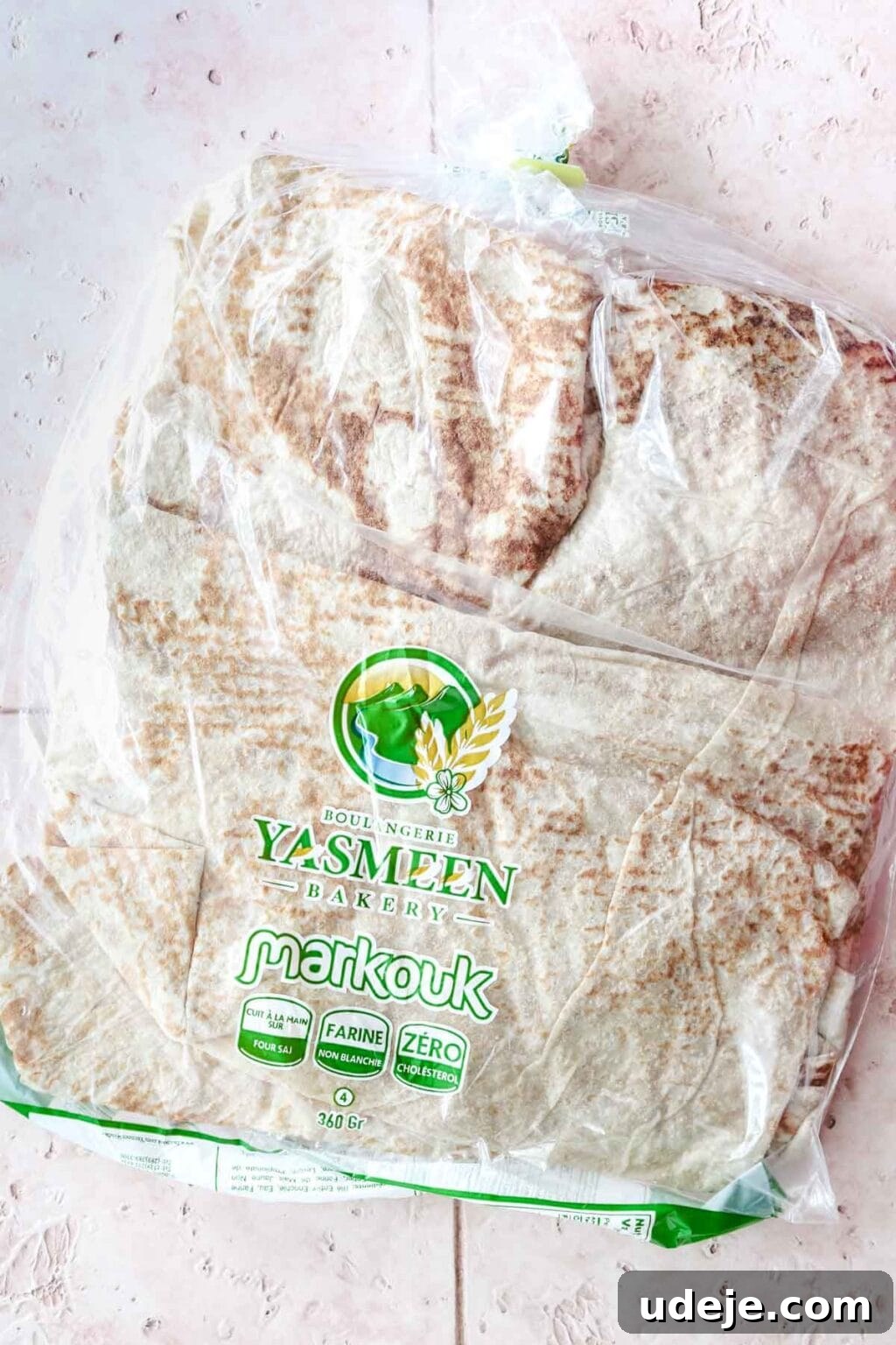 Sumac-Spiced Chicken Musakhan Crisps 7 Markouk bread in a clear package on a light coloured background, highlighting its thin texture.