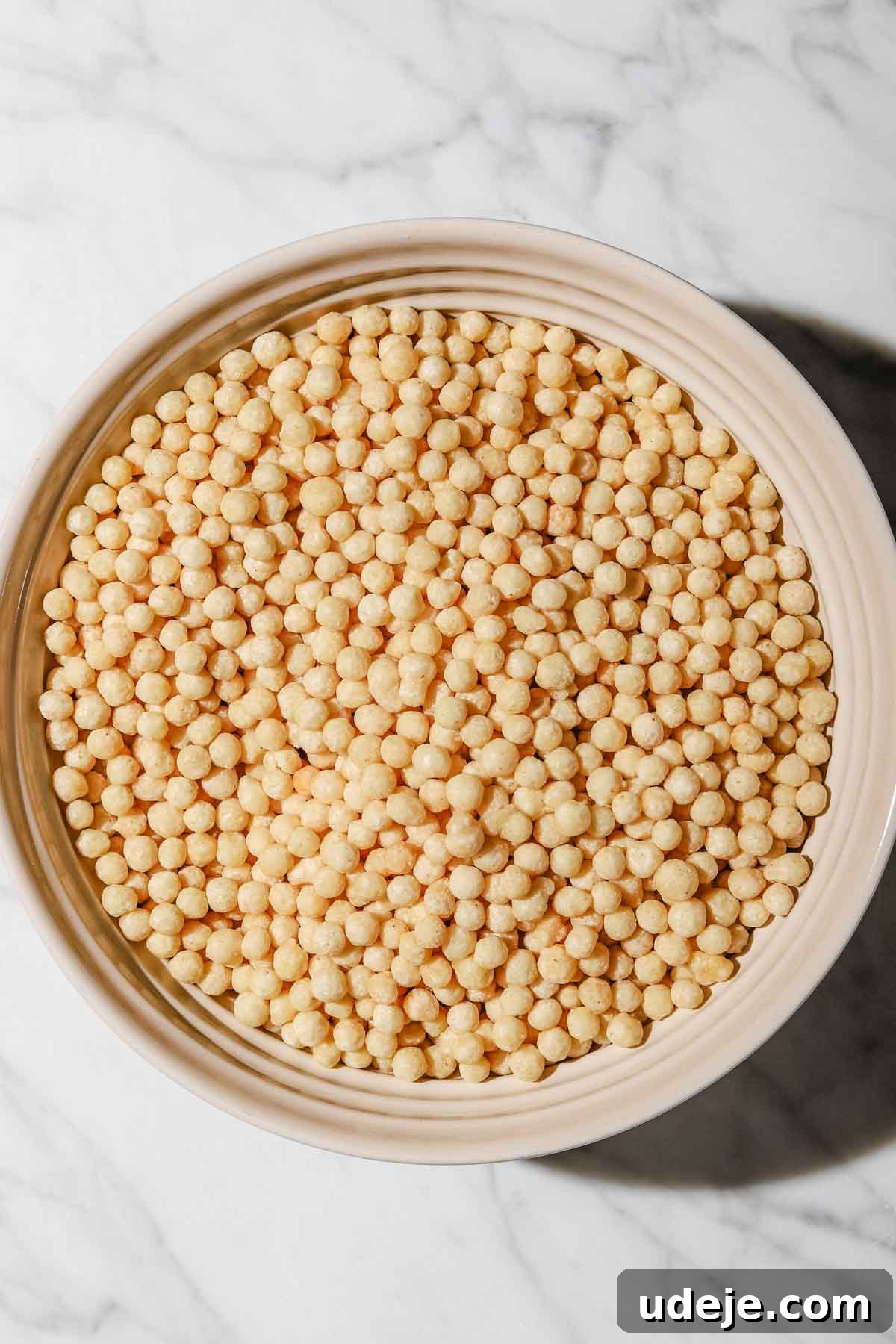 Lebanese Moghrabieh Pearl Couscous Delight 3 Moghrabieh pearl couscous in a large beige bowl on a marbled background