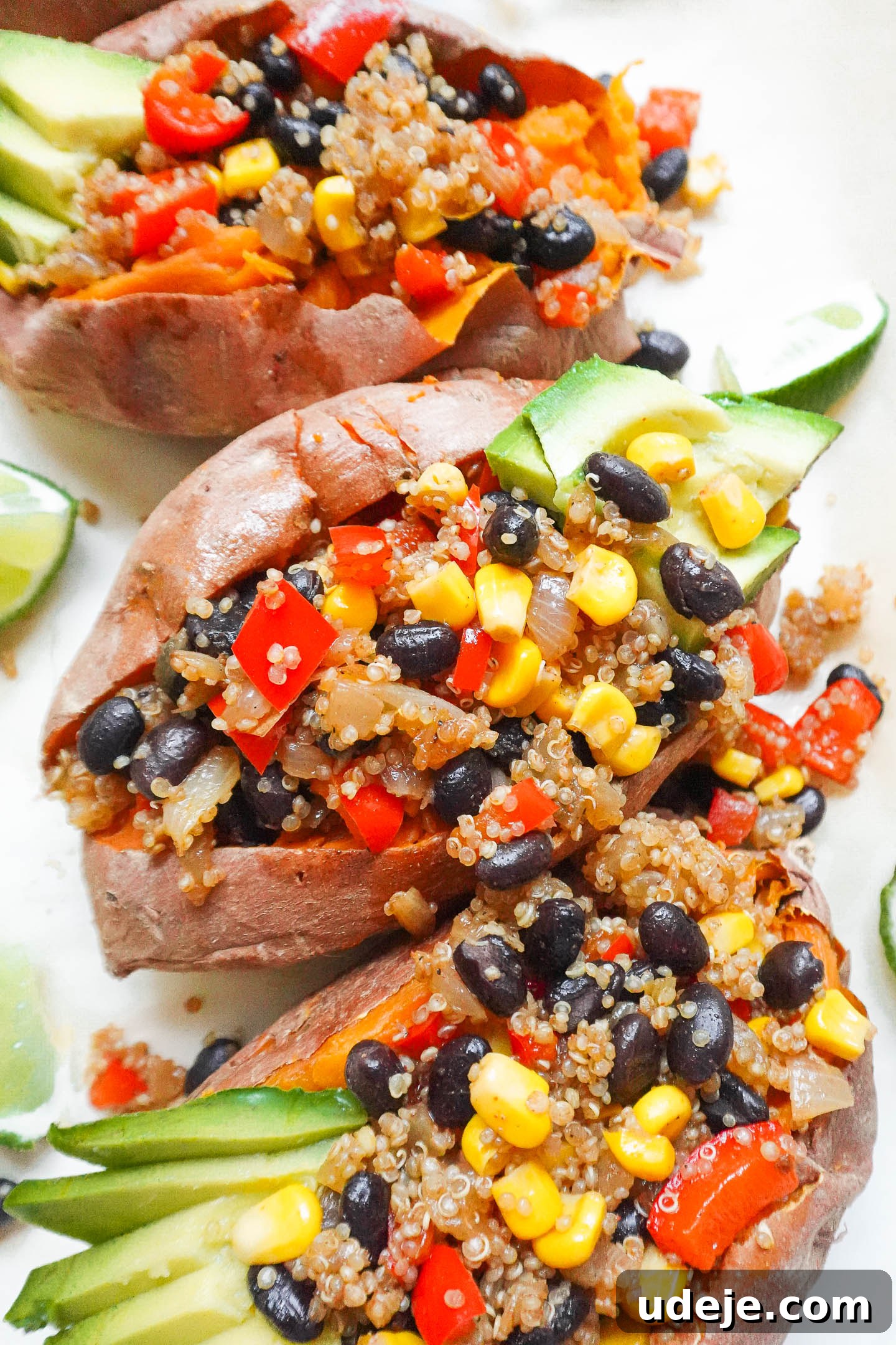 Close-up shot of a Quinoa Stuffed Sweet Potato with avocado and lime.