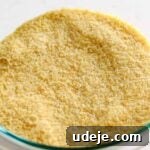 Angled shot of fine bulgur in a glass bowl on a light marble background