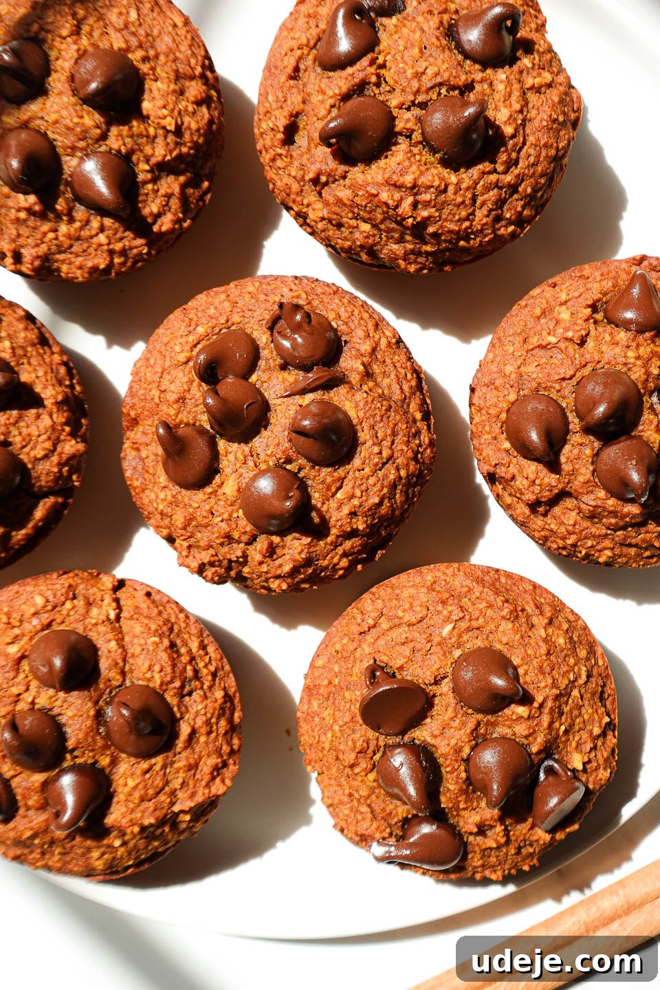 Delicious Plant Based Gluten Free Pumpkin Muffins 2 overhead shot of healthy pumpkin muffins on a plate garnished with a cinnamon stick
