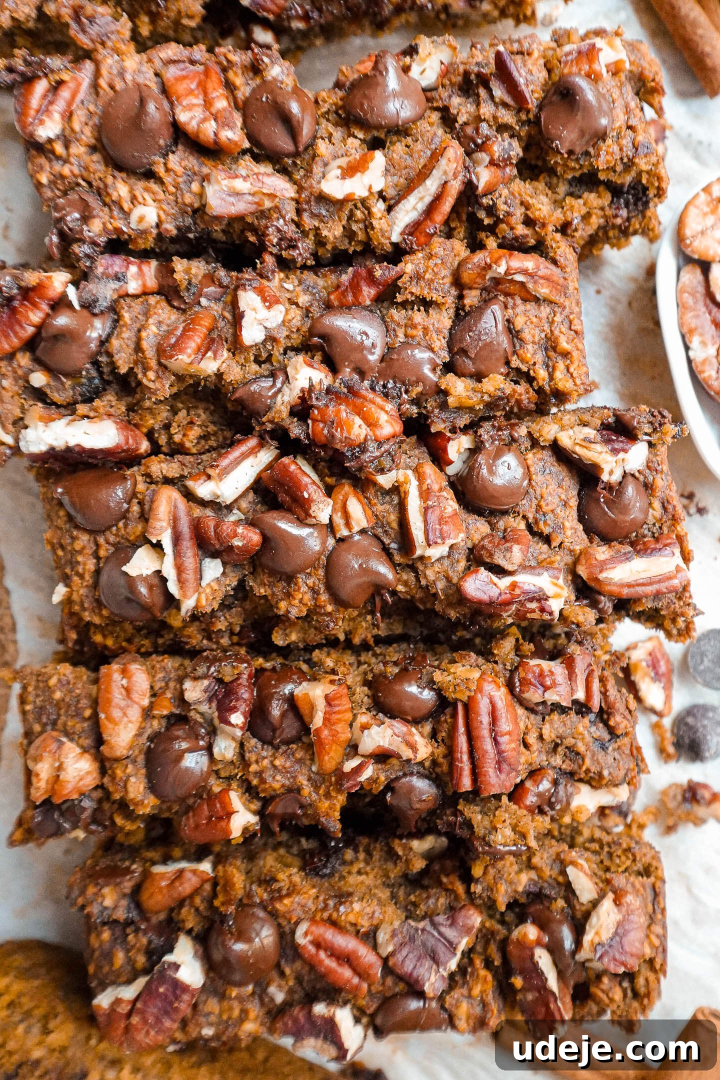 Warm Spiced Vegan Gluten Free Pumpkin Banana Bread 3 Close-up of a slice of pumpkin spice banana bread showing moist texture, chocolate chips, and pecans