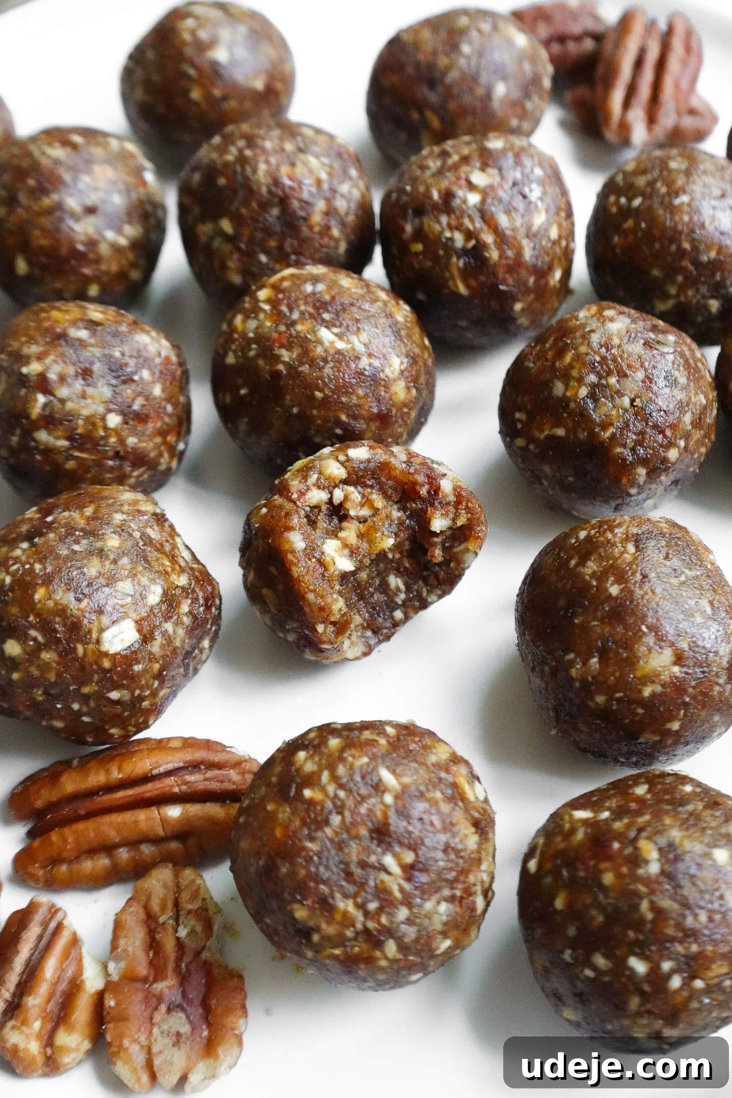 Pecan Pie Power Bites 3 Close-up of vegan Pecan Pie Energy Balls with a bite taken out of it