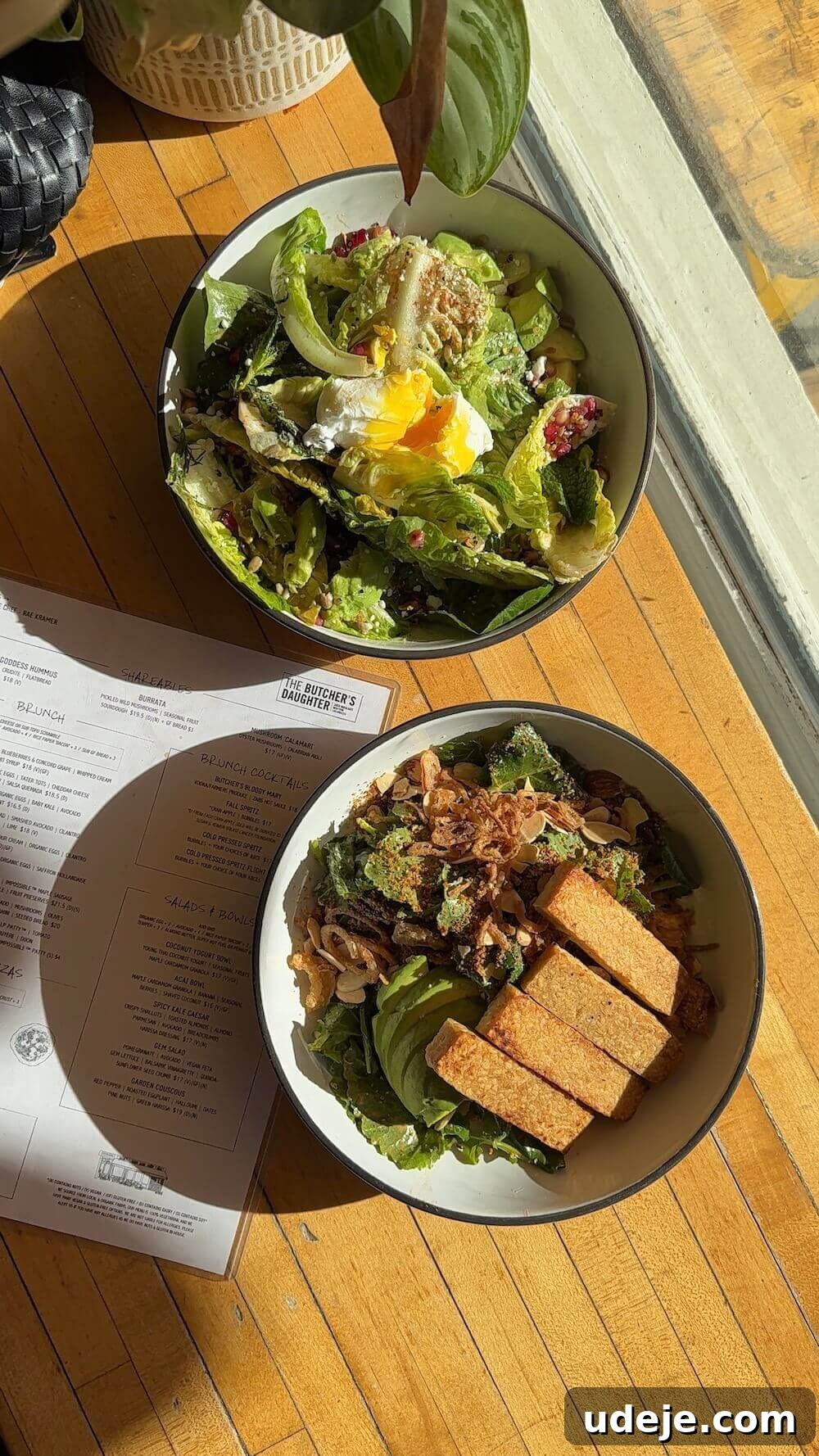 The Ultimate New York City Vegan Restaurant and Cafe Guide 11 Spicy kale caesar salad with tempeh at The Butcher's Daughter, a trendy plant-based restaurant in NYC.